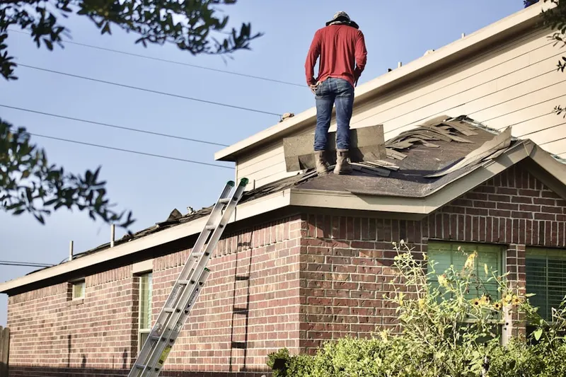 Professional roofer working on a residential roof in Verdera Village